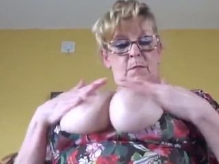 Lusty amateur blond haired granny in glasses masturbates her twat