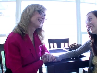 A beautiful MILF surprises a woman in bed