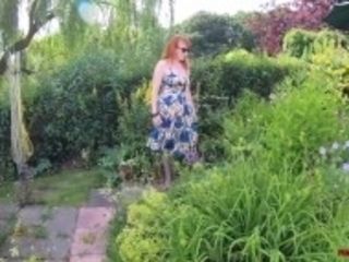 "Busty babe Red XXX fingers herself in the garden"