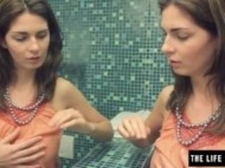 "Sexy brunette watches herself in the mirror as she masturbates"